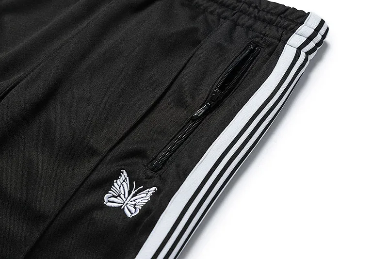 Mäns Needles-spår Fritidsbyxor Streetwear AWGE Träningsbyxor Kvinnor Herr Randig Dragkedja Byxa Butterfly Broderi Joggers Needles_voghion.com