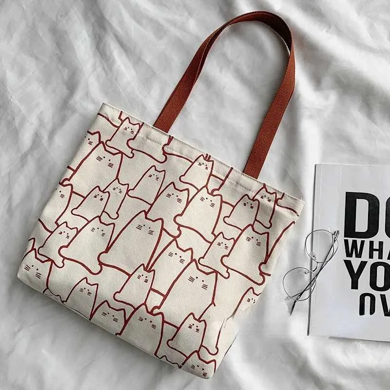 Canvas 2023 fashionable cute cat handbag messenger with zipper designer womens cartoon shoulder shopping bag Y241011_voghion.com
