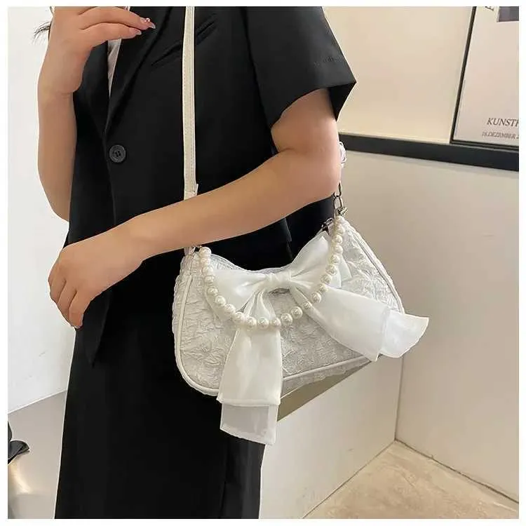 Bolsa de ombro e tiracolo feminina com pérolas e laço_voghion.com
