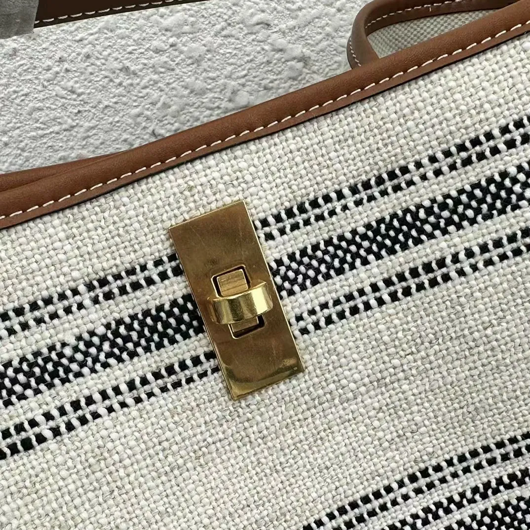 Borse firmate grigie: borsa a secchiello in tela a righe con dettagli in pelle e tracolla lunga regolabile_voghion.com