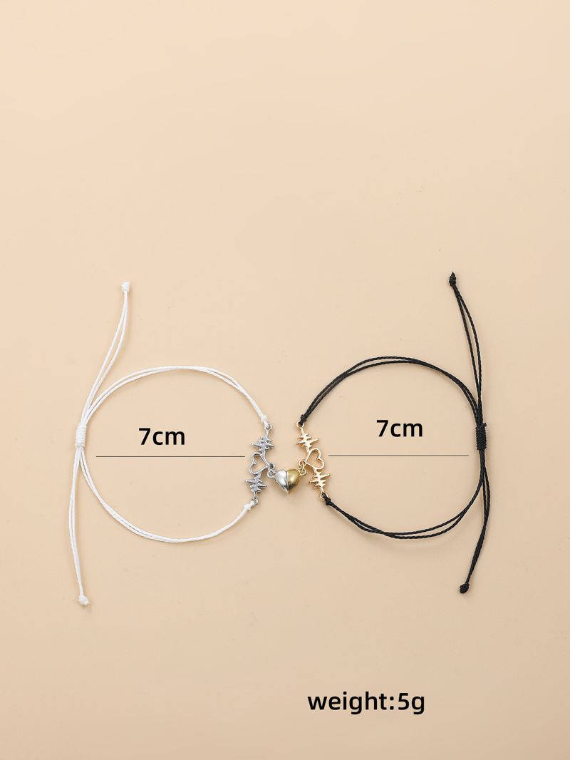 Coppia di braccialetti magnetici a forma di cuore intrecciati a mano in bianco e nero_voghion.com