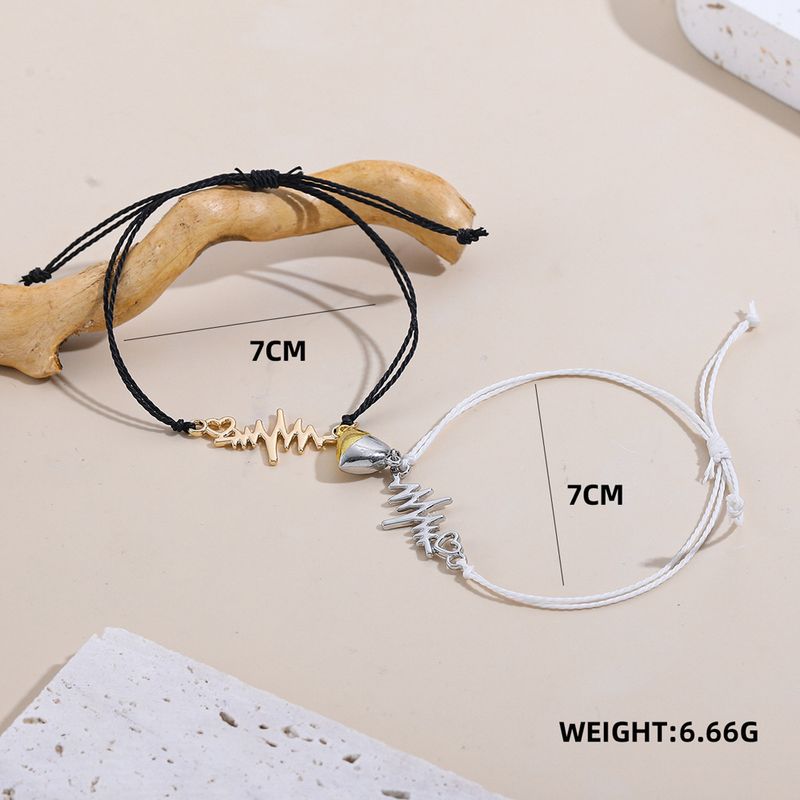 Coppia di braccialetti magnetici a forma di cuore intrecciati a mano in bianco e nero_voghion.com