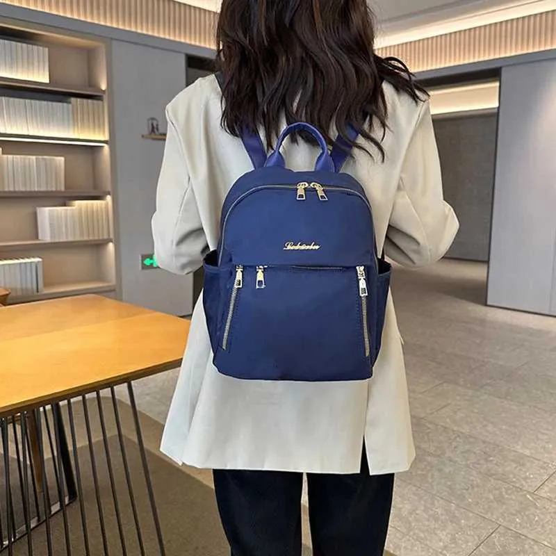 Sac à dos à la mode en nylon imperméable à haute capacité avec fermeture éclair solide 2024 hot selg Sac polyvalent pour femme Mujer Mochila_voghion.com