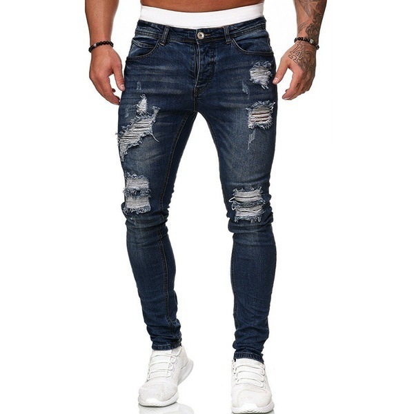 Los pantalones de los hombres rasgaron los pantalones delgados del dril de algodón forman los pantalones del becerro para los hombres