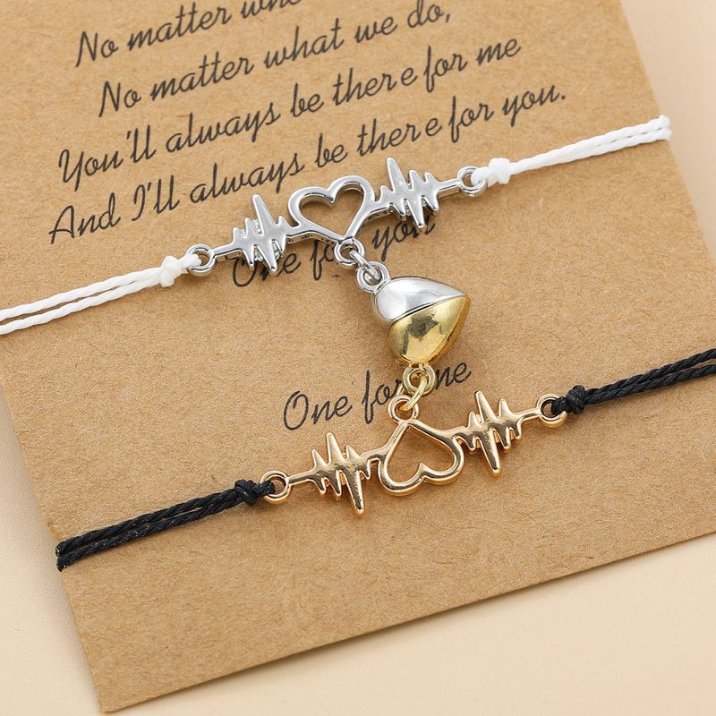 Coppia di braccialetti magnetici a forma di cuore intrecciati a mano in bianco e nero_voghion.com