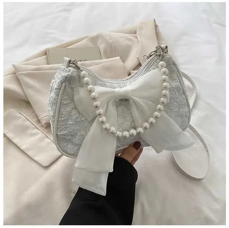 Bolsa de ombro e tiracolo feminina com pérolas e laço_voghion.com