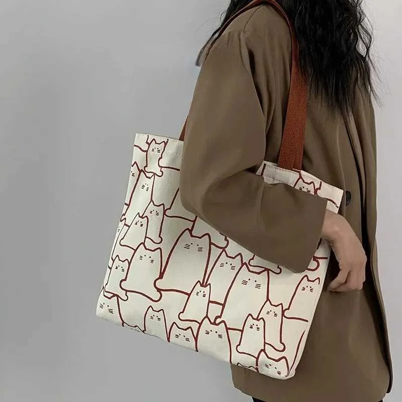 Canvas 2023 fashionable cute cat handbag messenger with zipper designer womens cartoon shoulder shopping bag Y241011_voghion.com