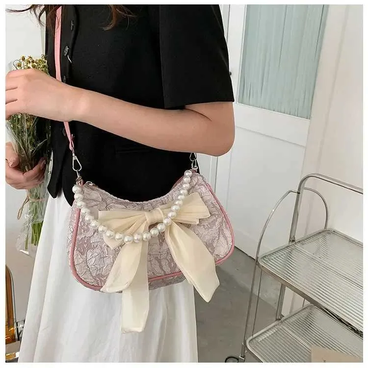 Bolsa de ombro e tiracolo feminina com pérolas e laço_voghion.com
