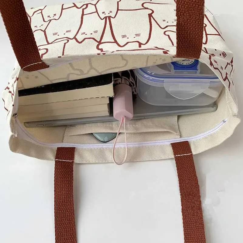 Canvas 2023 fashionable cute cat handbag messenger with zipper designer womens cartoon shoulder shopping bag Y241011_voghion.com